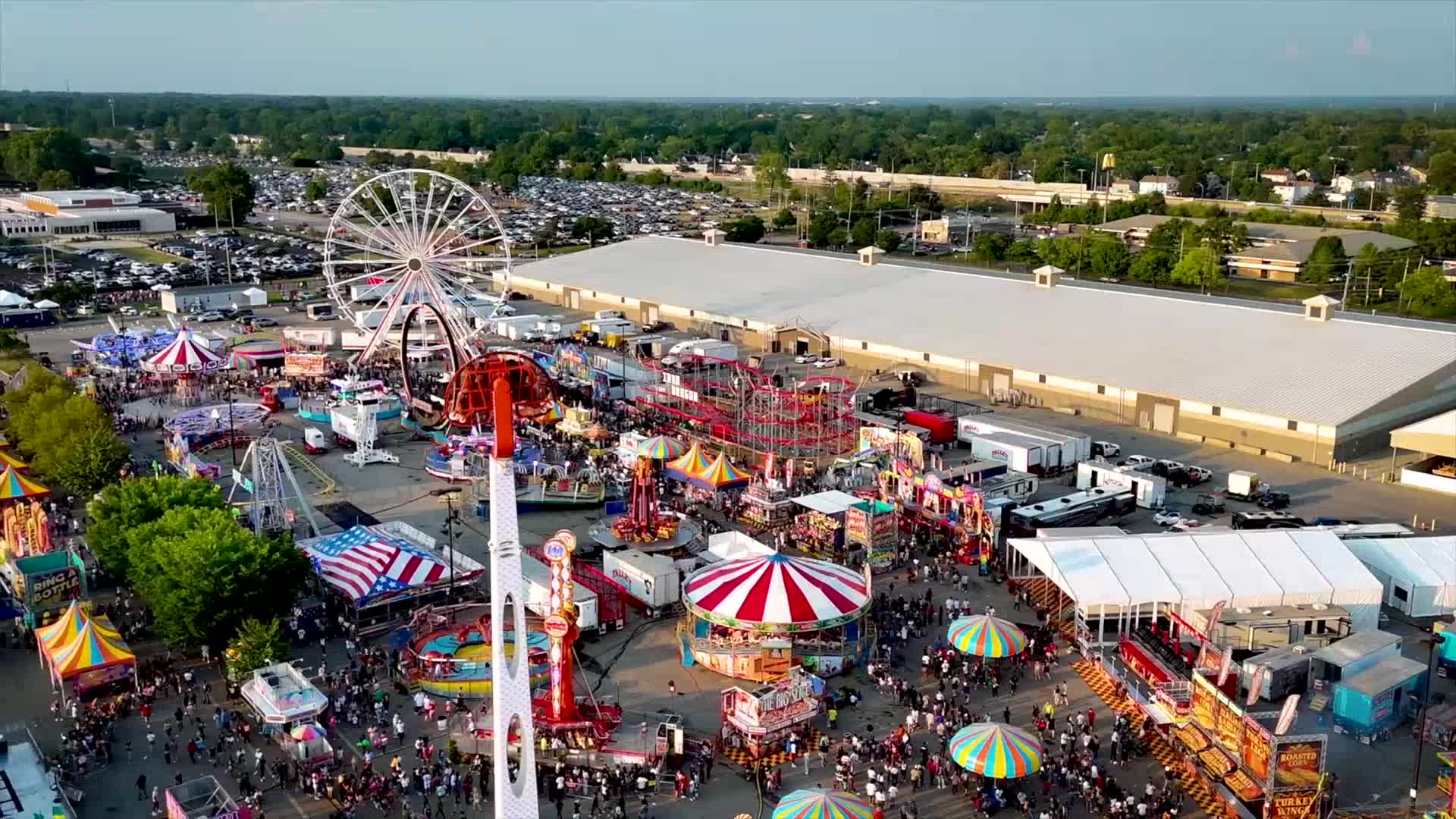 Aerial view of the Ohio State Fair grounds at dusk, ferris wheel and midway lit up